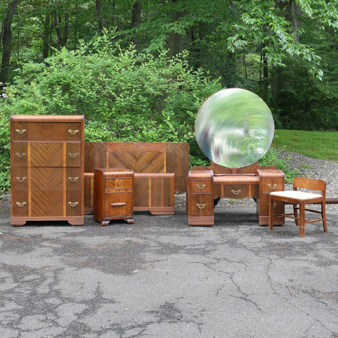 (4pc) ART DECO BEDROOM SUITE: Including a step down dressing table with round upright mirror, (h.66 x w.46 x d.18 in.) with bench, a tall chest (h.52-1/2 x w.34 x d.18 in.), a similar bedside table, and a full bedstead, (h.39 x w.