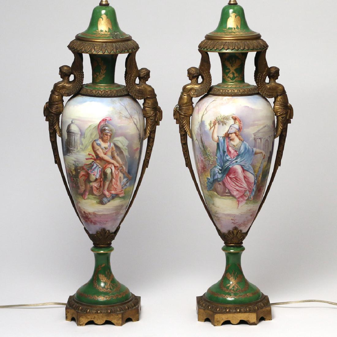 PAIR SEVRES-STYLE PORCELAIN VASES: 19th Century, ormolu mounts consisting of winged terms, Napoleonic bee and other gilt decorations, ovals with allegorical hand-painted scenes h. 24 in. (to sockets) w. 8 in. Condition: Chip to lid of 