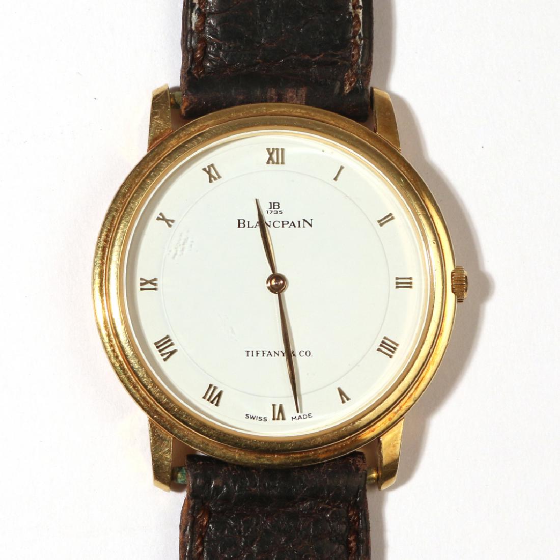 BLANCPAIN for TIFFANY & Co. WRISTWATCH: 18k yellow gold case with hallmarks, white dial with gold Roman numeral markers, gold hands, exhibition caseback, Ref No. 149 fitted with Cal. 21 ultraflat" manual wind movement, original tiffany & co