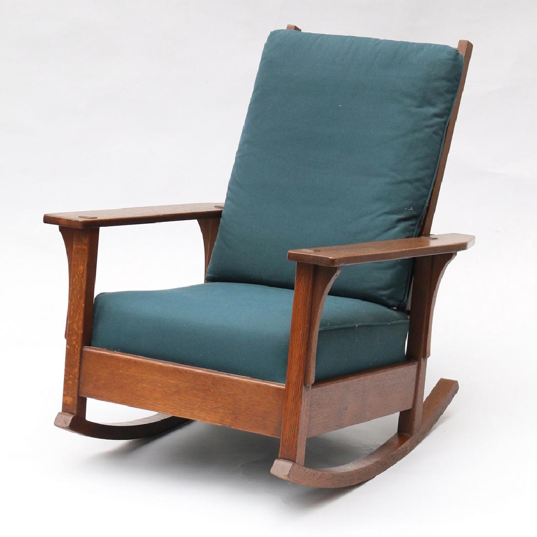 L & J.G. STICKLEY OAK ROCKER: marked with brand 'THE WORK OF L.& J.G. STICKLEY', with blue upholstery h. 38 w. 29-1/2 d. 33 in.
