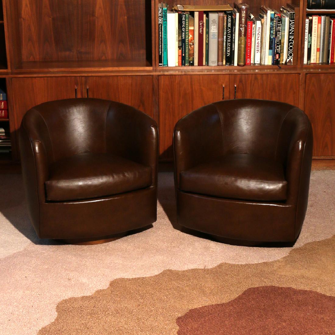 PAIR MILO BAUGHMAN FOR THAYER COGGIN SWIVEL CHAIRS: in brown vinyl upholstery, early 1980s h. 26 w. 28 d. 29 in. Condition: upholstery appears to have a greasy residue (someone may have used leather cleaner on them?). The gallery believes this should w
