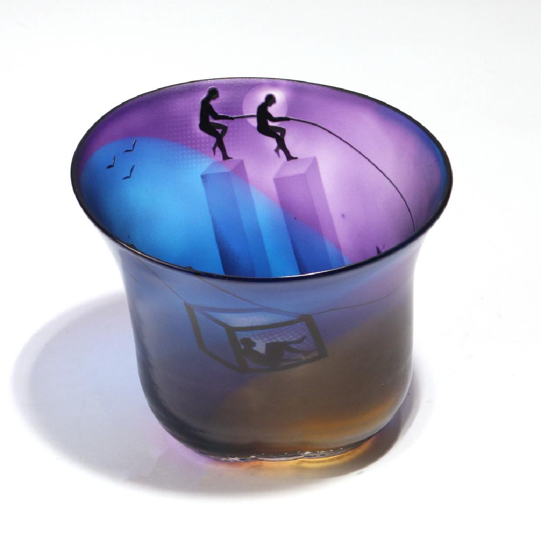 BERTIL VALLIEN GLASS VASE: depicting tightrope walkers and the Twin Towers on a blue, purple, and yellow ground, signed and marked Kosta Boda h. 5-3/4 w. 7 d. 6-1/2 in.