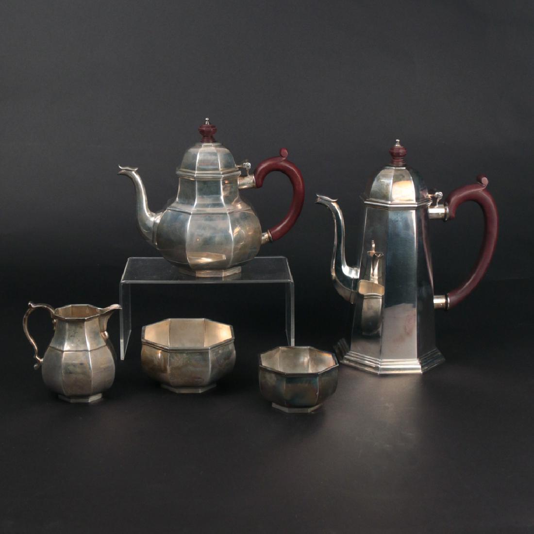 (5pc) TIFFANY STERLING AFTER DINNER SERVICE: Octagonal design with carved wood finials and handles after John Crouch & Thomas Hannam c. 1800; Including a coffee pot (h. 10-1/2 in., 40.3ozt), a teapot (h. 7-1/4 in., 23.8ozt), an open creamer (h. 