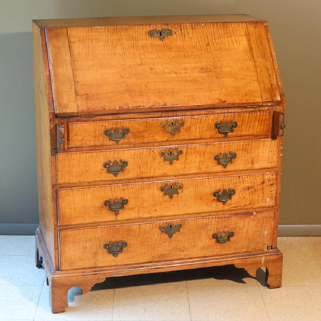 TIGER MAPLE SLANT-LID DESK OF SMALL SIZE: early 19th Century, old finish and original pulls h. 42-1/2 w. 37-1/2 d. 19-1/4 in. Provenance: Estate of Late Hazel M. Weiner, Monroe, CT Condition: piece missing from lower drawer front, rear legs m