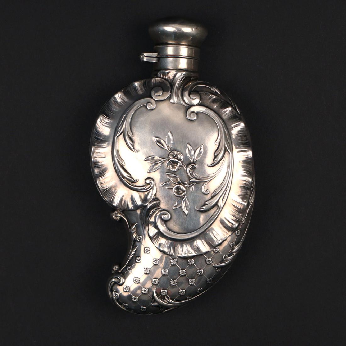 GORHAM STERLING SILVER FLASK: decorated with classical designs, monogrammed 'EM', 4 toz h. 6 w. 3 in. Condition: dent on one side and on lid