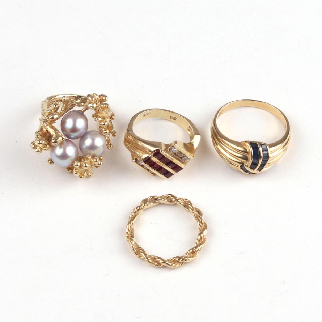 (4pc) GEMSTONE & GOLD RINGS: Including a Tiffany & Co. sapphire & 14k gold ribbon form ring (size 7-3/4, 3.7g); a coral-form pearl and 14k gold ring (size 4-1/4, 9.4g); a garnet, diamond, and 14k gold ring marked DCK" (size 4.5, 