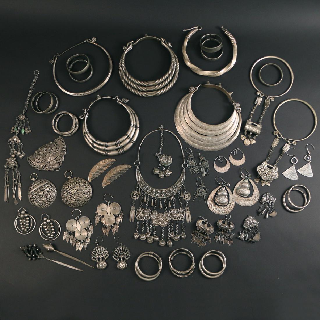 LOT OF MIAO / TIBETAN JEWELRY: silver and/or silver-alloy, including 5 torques; 2 chokers with lock-box pendants; 1 necklace with hanging pendants; 9 pairs of earrings; 2 round reticulated pendants; 1 butterfly pendant; 1 long tass
