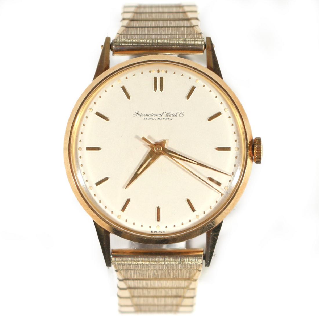 GENTLEMAN'S GOLD IWC WRISTWATCH: C. 1960's manual wind, grey dial with gold baton numerals, case marked "International Watch Co. - Swiss - 1597065", 36mm over crown, with a later expanding gold plated band, watch case appx. 31.5g (in
