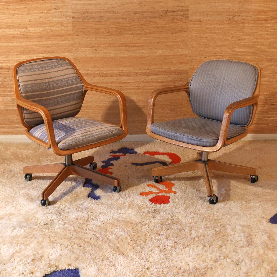 PAIR DON PETITT FOR KNOLL 1105 DESK CHAIRS: 1960s, bentwood design, each with differing upholstery and casters, unmarked h. 33 w. 24 d. 25 in.