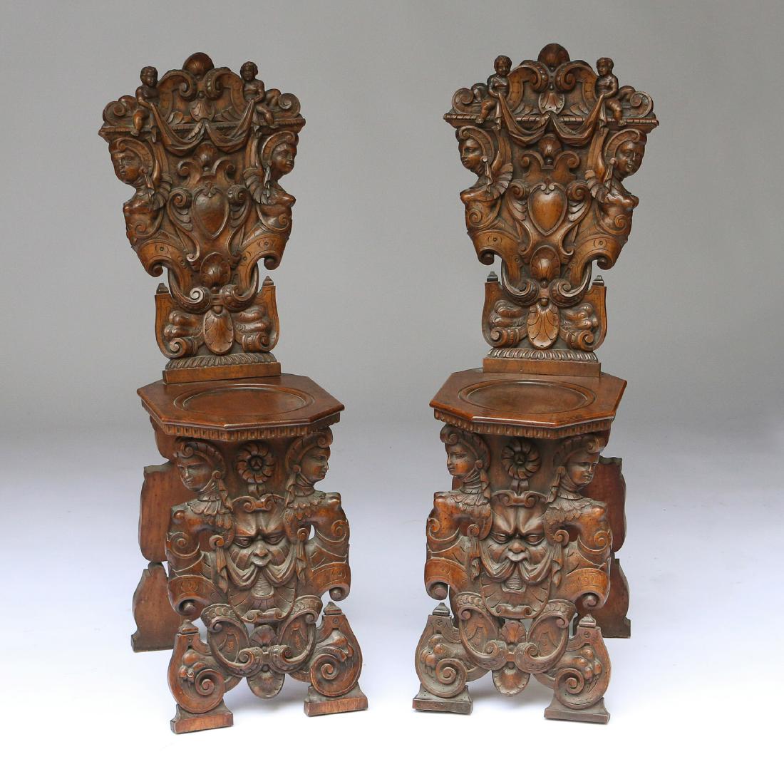 PAIR ITALIAN BAROQUE CARVED HALL CHAIRS: 18th/19th Century, walnut carved in heavy relief with various classical designs