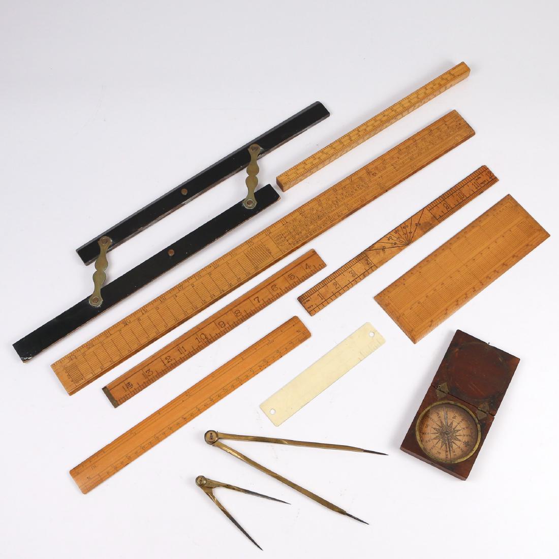 (11pc) NAUTICAL DRAFTING & SURVEYING INSTRUMENTS: including 7 misc. boxwood rulers; 1 ebony parallel rule; 2 brass dividers; 1 antique cased wooden compass [broken glass] w. 24 in. (longest)