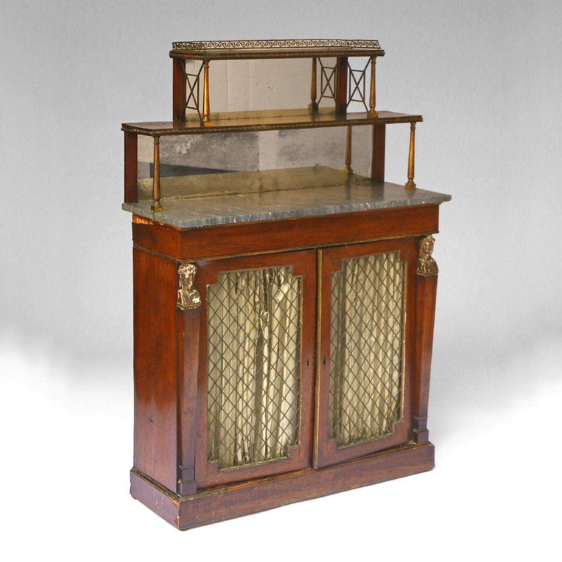 REGENCY ROSEWOOD CHIFFONIERE: Ca 1820, having a tiered step back superstructure crested by 3/4 gallery with ormolu side supports, over grey marble top, over two full-width doors with grillwork, flanked by Egyptian monopodia h. 52 