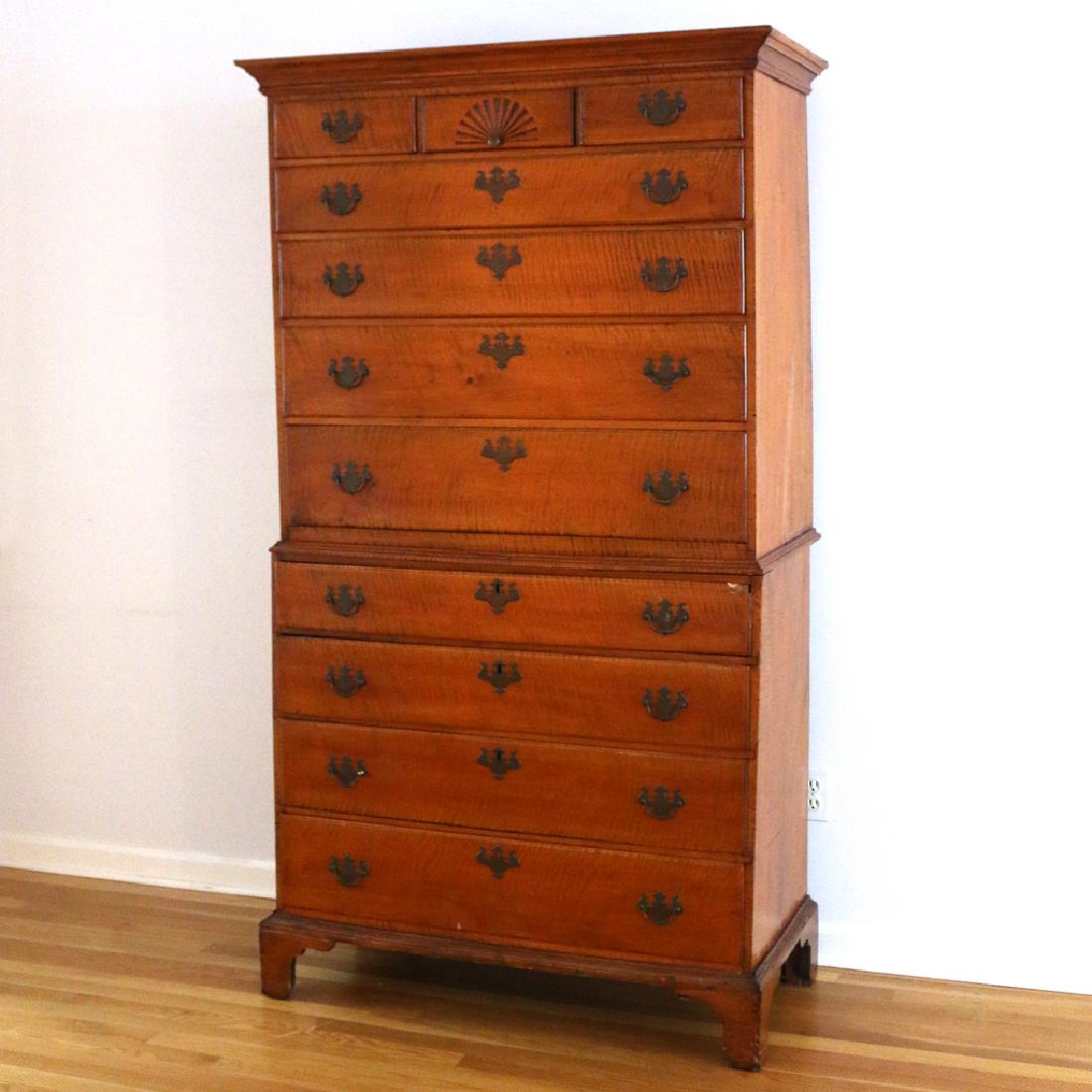 18THC. NEW ENGLAND TIGER MAPLE TALL CHEST: 2-pc. construction, upper case crested by projecting cornice molding over 3 small drawers, one with carved fan, over 4-graduated long drawers; lower case with 4-graduated long drawers mounted on brack