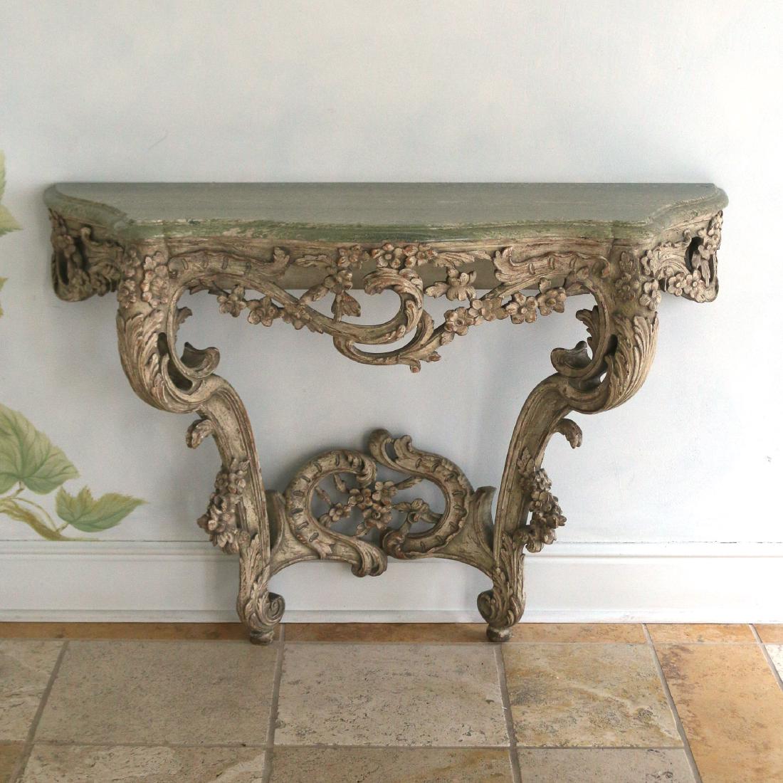 ROCOCO-STYLE CARVED MARBLE TOP CONSOLE TABLE: 20th Century, with shaped green marble top over conforming C-scroll wall-mounted base h. 34 w. 49 d. 15 in.