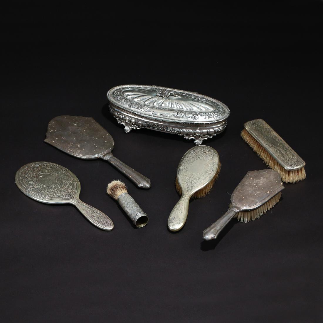 (7pc) SILVER DRESSING ITEMS: Including a 4-piece dressing set by Tiffany & Co., comprising a hand mirror, hair brush, clothes brush, and powder brush; plus a hand mirror and hair brush; and an 800 silver oval box, 22 ozt (the box