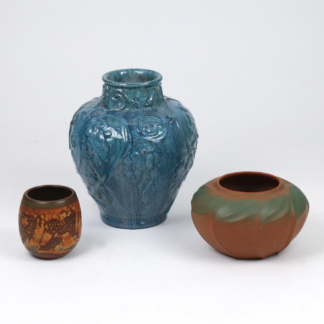 (3pc) AMERICAN ART POTTERY: including a Candler North Carolina baulster vase with blue flambe glaze and molded grape designs, signed 'P s&G [?] / Candler / 25'; a Van Briggle squat vase with molded leaves on a brown ground, sign