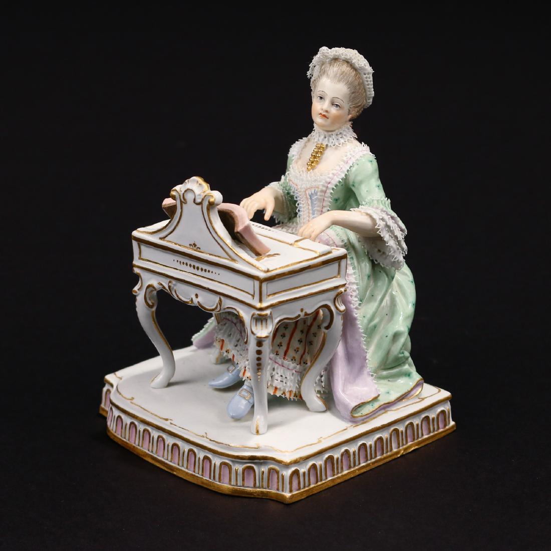 MEISSEN FIGURE, 'HEARING': depicting a woman at the harpsichord, from the series on the five senses modeled by J. C. Schoenheit, with blue crossed-swords mark, incised 'E.1', and impressed '43' h. 4-3/4 in.