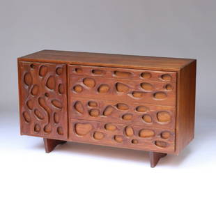 MID-CENTURY WALNUT CHEST OF DRAWERS: custom-made with solid timbers, with pierced drawer-fronts in a coral-reef design h.32 x w.54 x d.20 in. Provenance:Purchased by the consignor in directly from 'a custom builder' in New York City c. 1