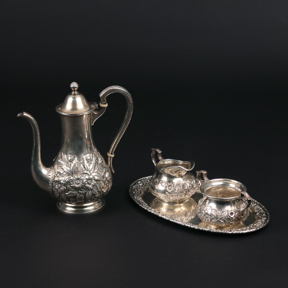 (4pc) S. KIRK & SON STERLING SILVER TEA SET: with floral decorations in repousse, including a teapot, creamer, sugar, and oval tray, 27 ozt total h. 8 in.