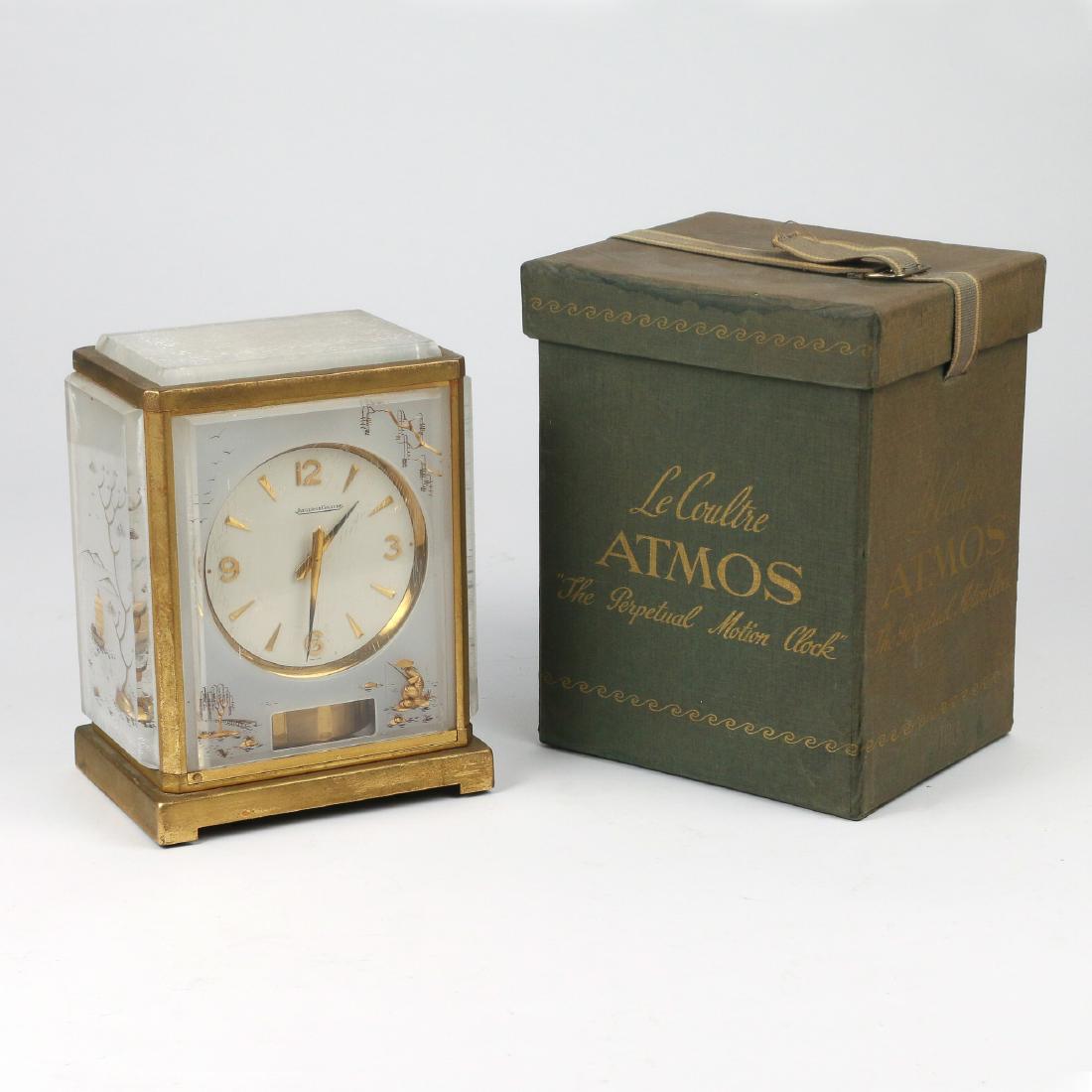 JAEGER LeCOULTRE JAPONESQUE SHELF CLOCK: A Jaeger LeCoultre Atmos Shelf Clock with reverse etched and gilt arcrylic panels showing Japanese scenes, in original "LeCoultre ATMOS Perpetual Motion Clock" lidded box with ribbon h. 9-1/4 w. 6-1/2