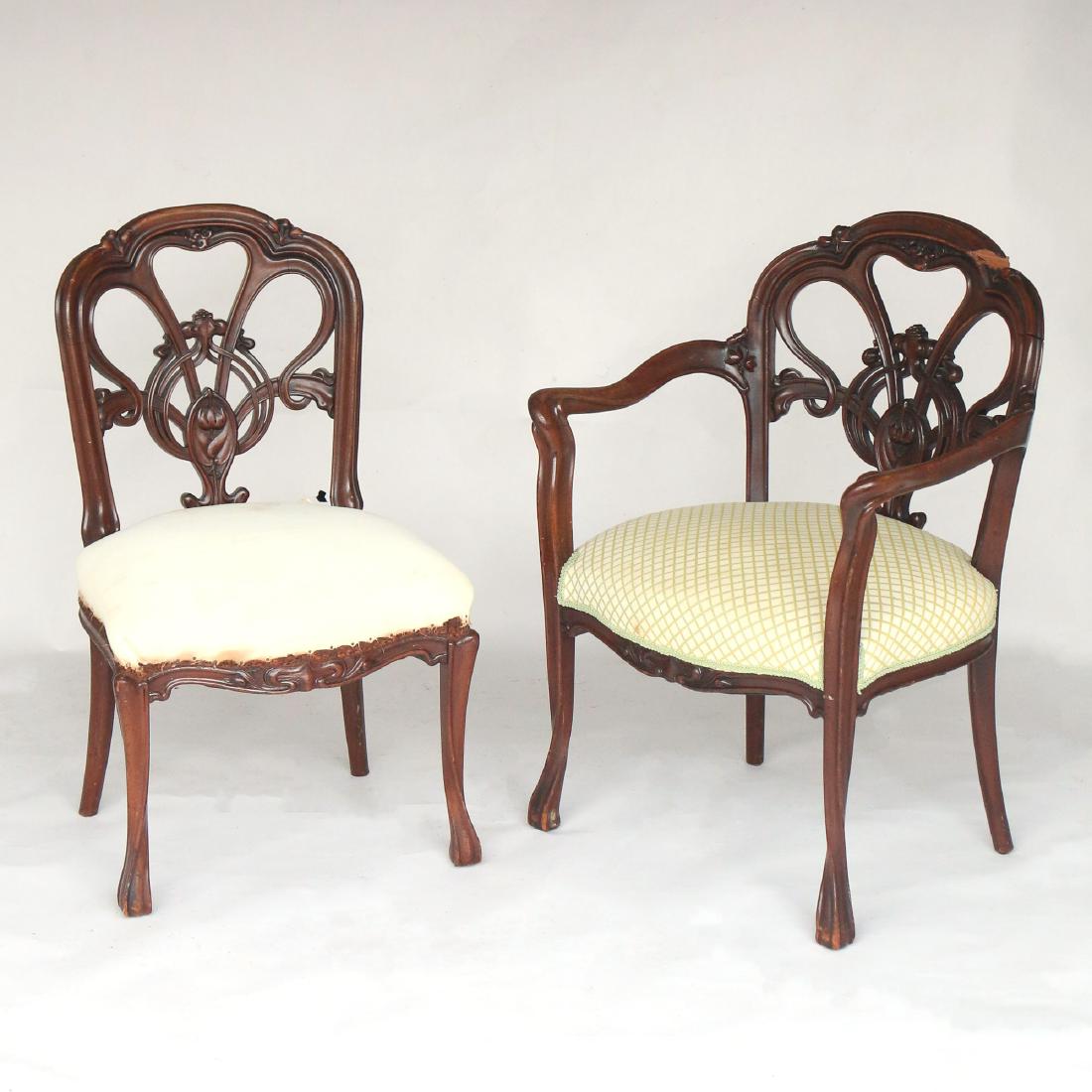(2pc) ART NOUVEAU CHAIRS: in the style of Louis Majorelle, including one arm chair and one matching side chair h. 34 w. 25 d. 19 in. Condition: armchair with loose pieces and losses to crest