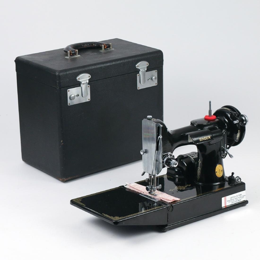 SINGER TRAVEL SEWING MACHINE: Black painted stencil decorated travel sewing machine (s/n: AJ141752), fitted case with parts and misc. sewing items h. 12 w. 14 d. 9