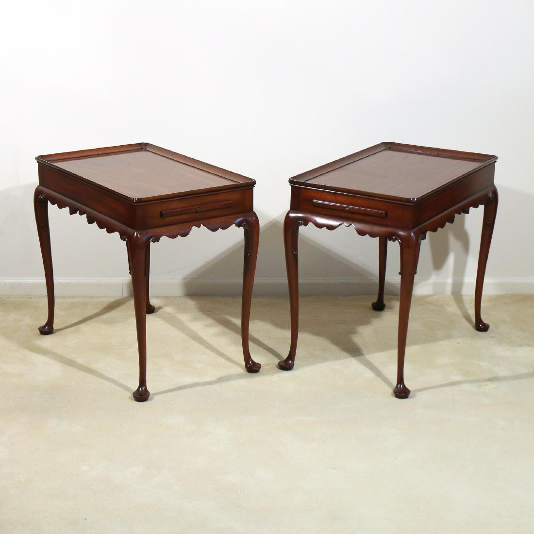PAIR KITTINGER WILLIAMSBURG TEA TABLES: 20th Century, Boston Queen-Anne style in mahogany with rectangular dish tops, candle slides, shaped aprons and cabriole legs, with Kittinger Williamsburg brand and Kittinger Buffalo paper label h. 26-