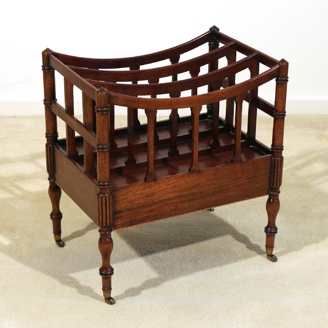 REGENCY MAHOGANY CANTERBURY: with turned legs and brass casters h. 20-1/2 w. 19 d. 13 in. Condition: underside with red paint, likely concealing restorations