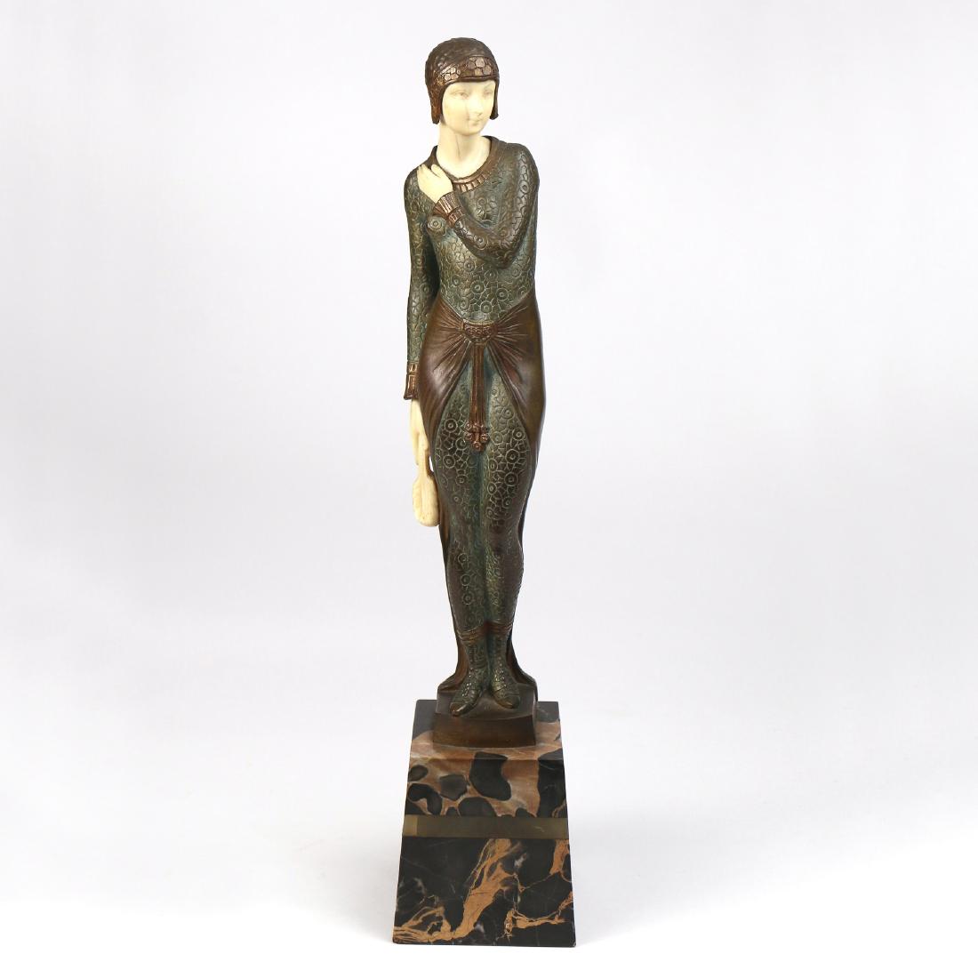 JOSEPH E. DESCOMPES (French, 1869-1950) BRONZE: Standing art deco figure of a woman holding a feather hand-fan, carved bone face and hands, wearing a bronze skullcap, signed “Joe Descompes” mounted on a tapering marble plinth h. 11-3/4 w. 2-3/4