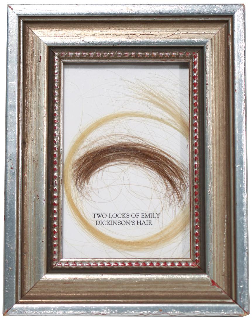 TWO LOCKS OF EMILY DICKINSON'S [?] HAIR: two locks of hair purportedly belonging to Emily Dickinson framed together, one of auburn color, the other a brownish-blonde. It appears that the only known locks of hair belonging to Emily Dickinson 