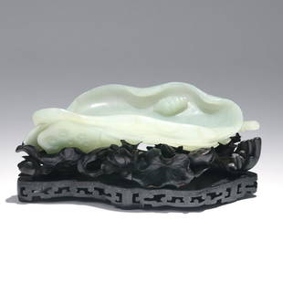 CHINESE CARVED JADE BRUSH WASHER & ZITAN STAND: Qing dynasty, the brush washer of an even pale celadon color carved in the form of a lotus leaf with incurved edges and a snail on the interior, with seed pod (symbol of fertility), stem, and frond be