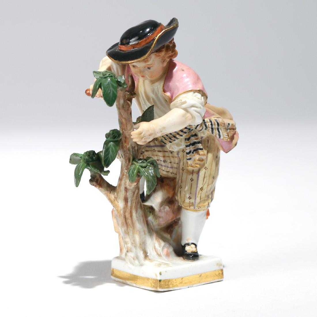 MEISSEN PORCELAIN ARBORIST FIGURINE: Depicting a young boy arborist in a black hat trimming a tree branch, crossed swords mark and impressed "G. 4. / 122" h. 4 in. Provenance: Greenwich, CT estate