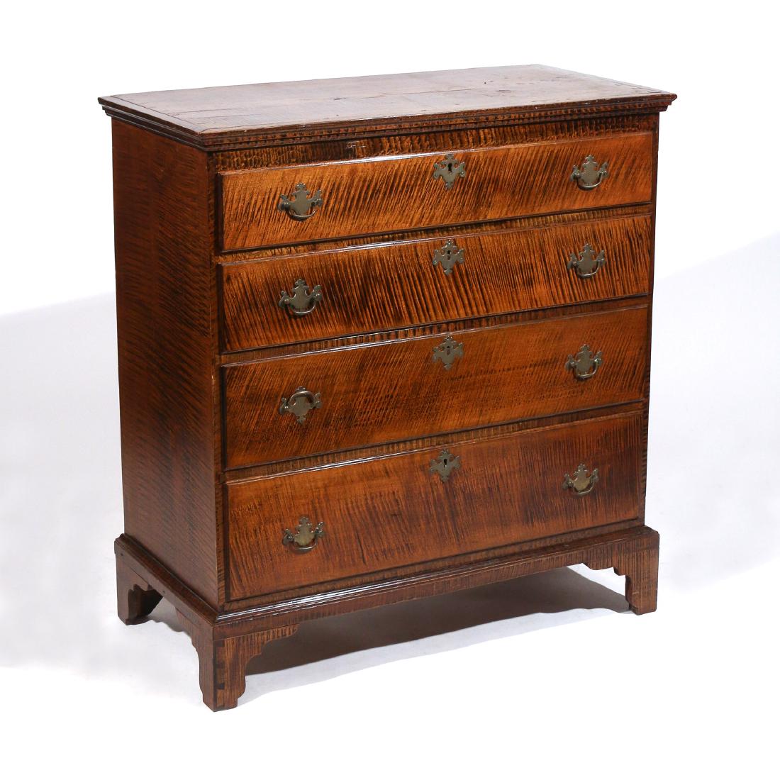 FEDERAL GRAIN-PAINTED CHEST OF DRAWERS: Late 18th Century, with molded cornice over four graduated drawers and bracket feet, decorated all-over with faux-tiger grain painting h. 41 w. 38 d. 19 in. missing locks, old splits on sides, pulls l
