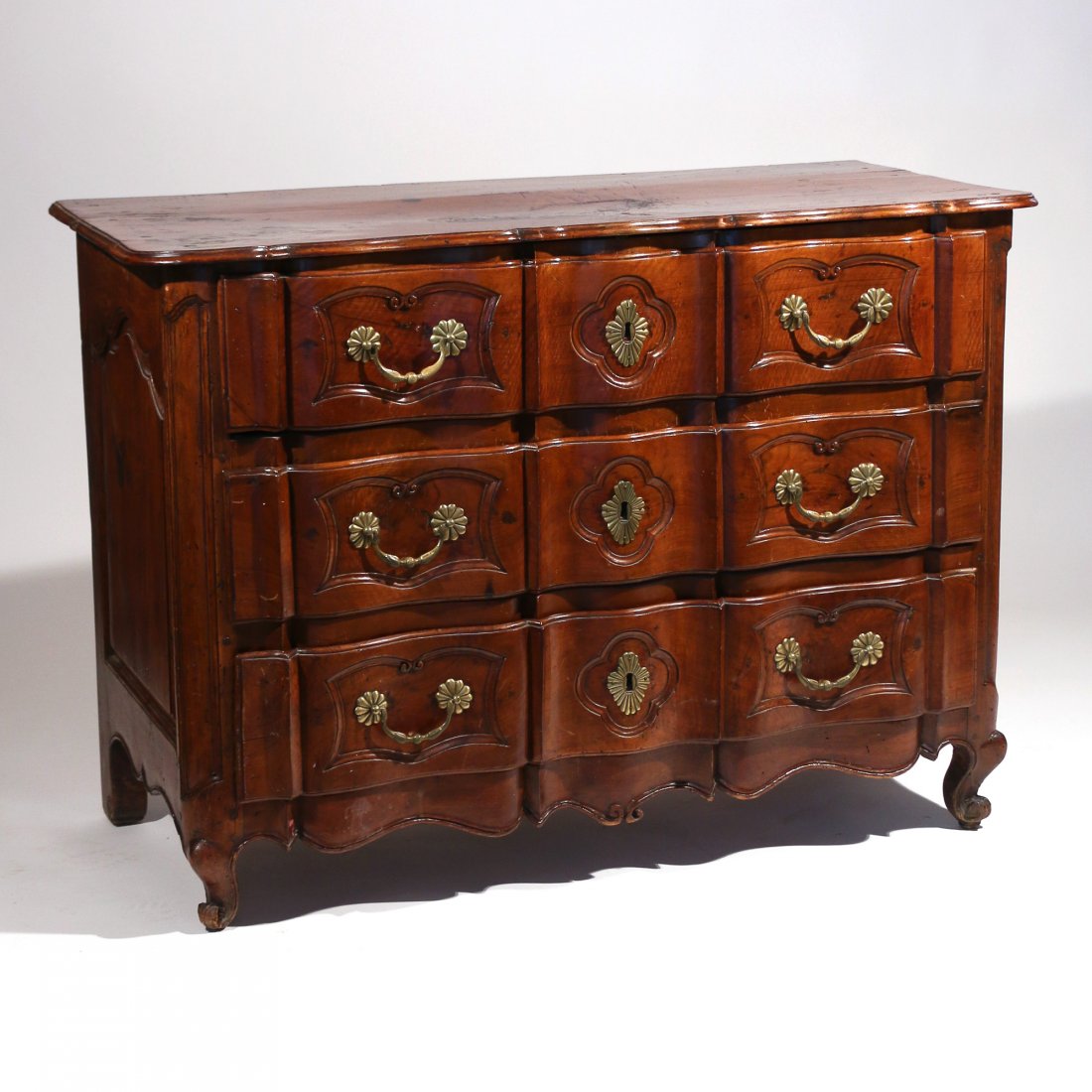 FRENCH PROVINCIAL WALNUT COMMODE: 18th/early 19th Century, having a shaped front with three drawers over cabriole legs h. 35 w. 49 d. 23 in.