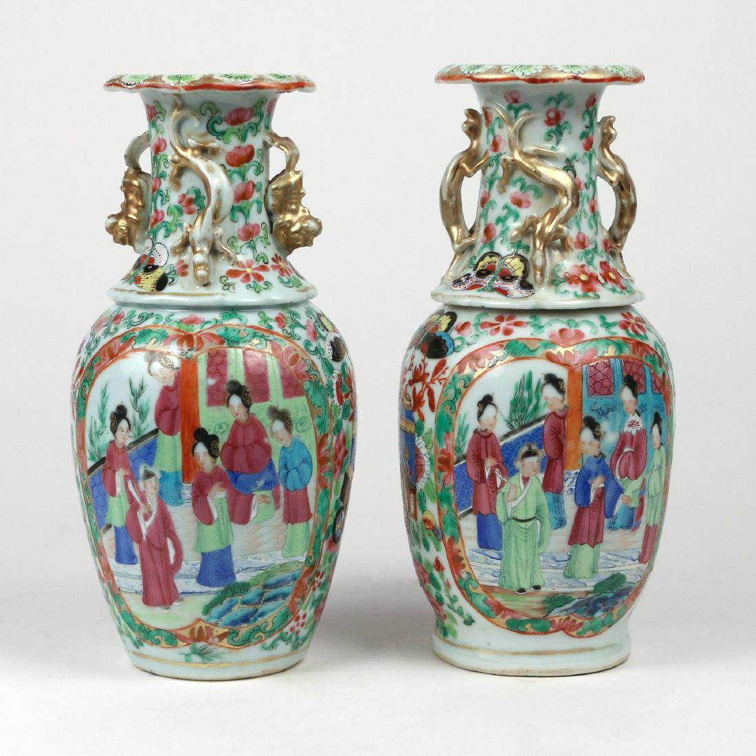 NEAR PAIR CHINESE EXPORT FAMILLE ROSE VASES: Enamel decorated porcelain, each with figures in reserves, butterflies, flowers and vines, and with applied foo dogs, lizards, and dragons at the neck Provenance: From the historic Revolutionary War h