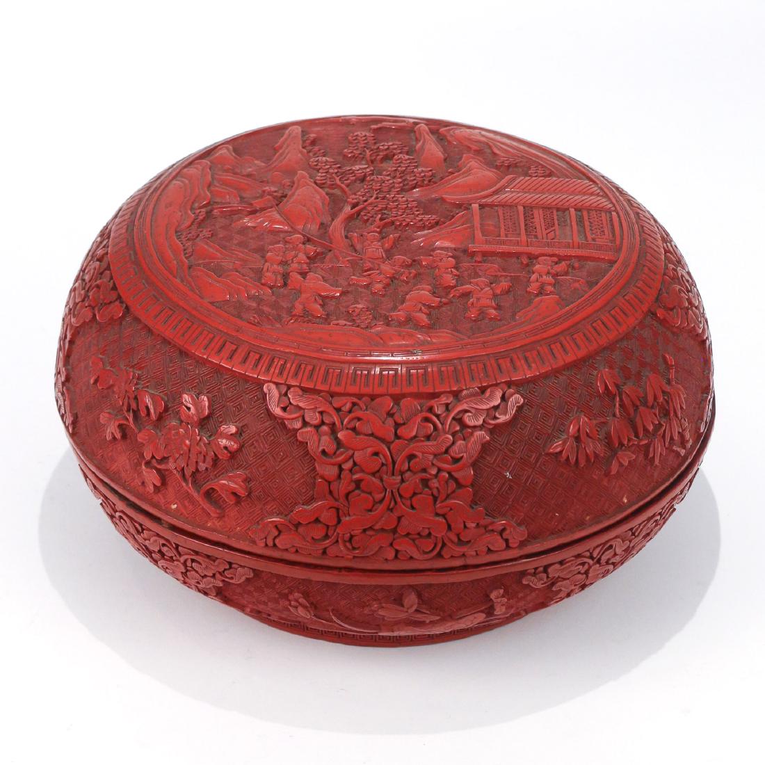 LARGE CHINESE CINNABAR FOOD BOX: 20th Century, of circular shape with a scene of boys flying a kite within landscape on the top, having removable partitioned tray h. 5-1/4 dia. 11 in. Provenance: Estate of John F. Ball, Television an