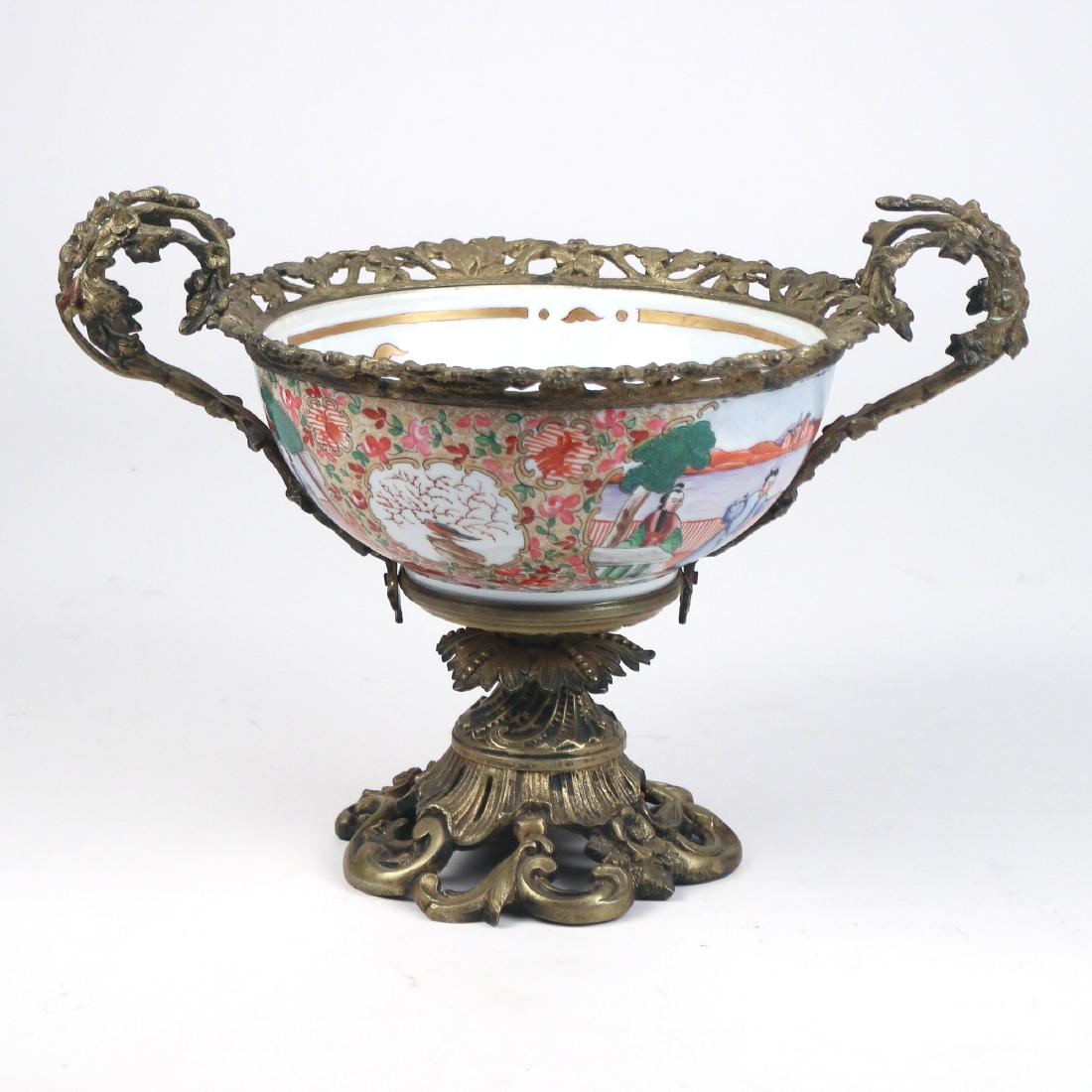 CHINESE PORCELAIN & ORMOLU CENTER BOWL: early 20th Century, with Chinese export porcelain bowl having figural scenes on a gilt floral ground, the mounts with classical scroll and floral designs h. 10 w. 14 d. 10 in. excellent--no condition 