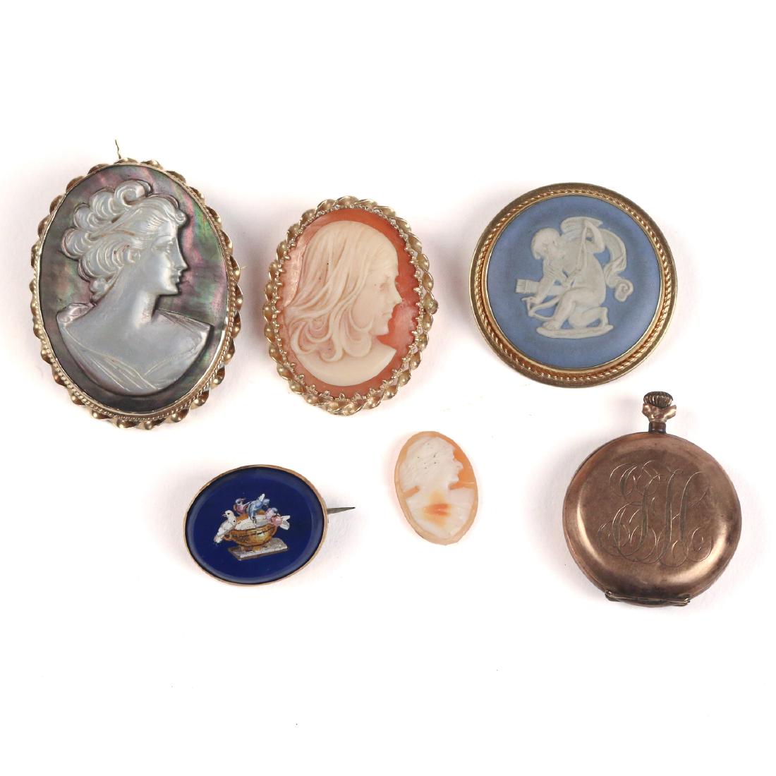 (6pc) COLLECTION CAMEO PINS & OTHER: Including a mother-of-pearl cameo pendant/ pin (l. 2 in.), a round wedewood bisque pin, a contemporary shell cameo pin, a small shell cameo with no surround, plus a small pocketwatch "Paskar Watch Co.