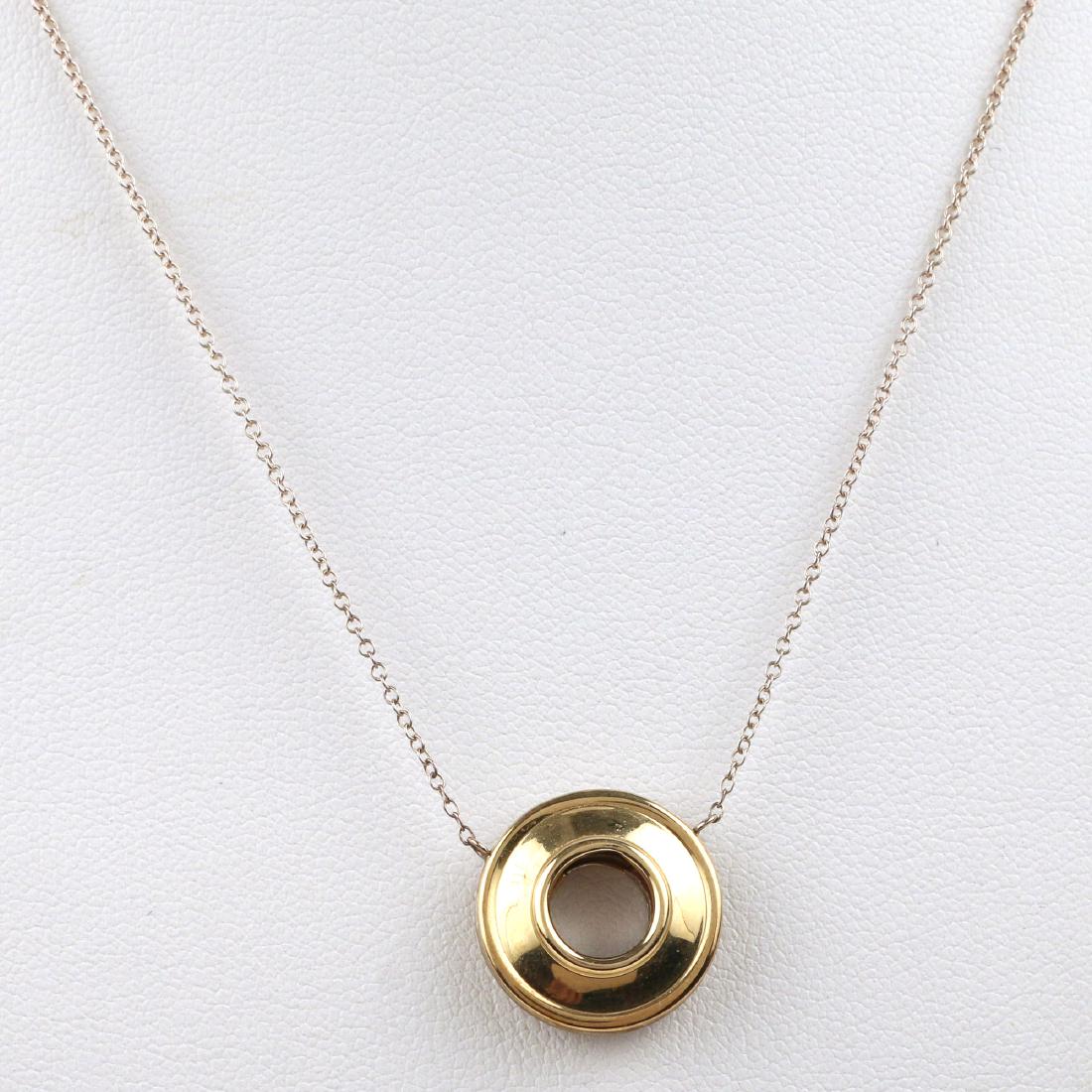 PALOMA PICASSO for TIFFANY & Co. GOLD & STERLING N: "Magic" pendant necklace, sterling and 18k gold formed circular pendant suspended from a fine link chain, 17 in., 3.3g Provenance: From the collection of a Greenwich, CT lady