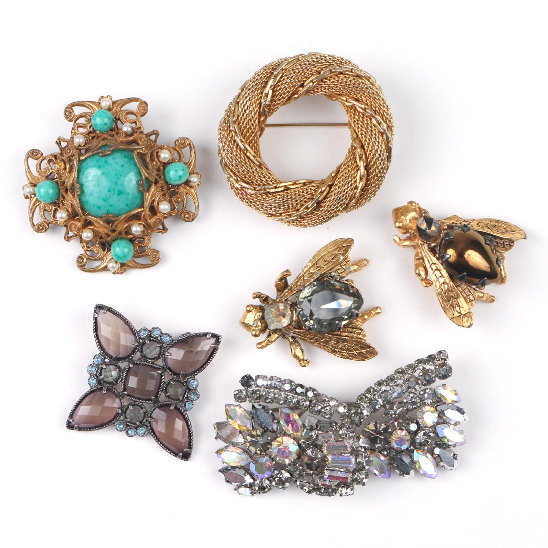 (6pc) COSTUME PINS: Including a pair of bee-form pins (both missing stones), a Miriam Haskell pin, a faux gold wreath form pin, a paste pin marked "Austria" and a faceted smokey quartz pin