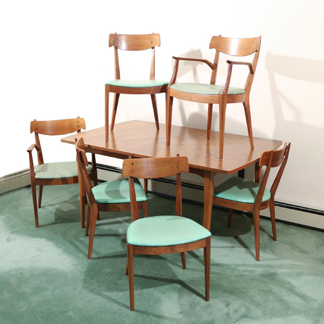 KIPP STEWART for DREXEL DINING SUITE: "Declaration" style; circa 1966, walnut, comprising two arm chairs (h.31 x 21 x 19 in.), four side chairs, and an extension dining table (h.29 x 60 x 40 in., plus two leaves each 22 in.) Provenance: P