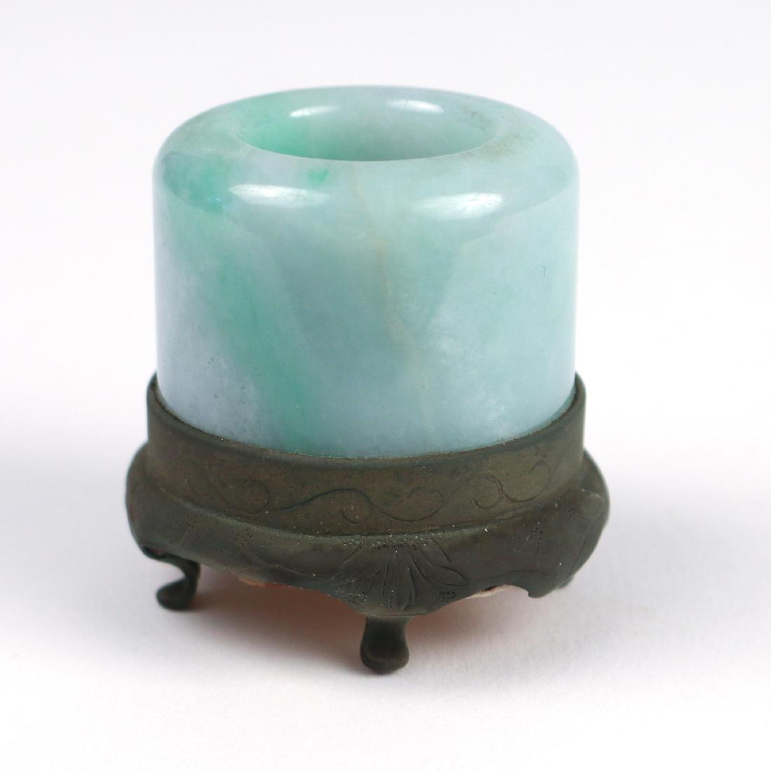 CHINESE JADE ARCHER'S RING: mounted in a footed metal base h. 1-3/4 dia. 1-3/4 in. Provenance: From the collection of a nonagenarian couple, Rye, NY