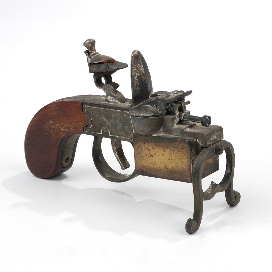 DUNHILL FLINTLOCK TINDER PISTOL LIGHTER: Square profile grip, underside marked "DUNHILL TINDER PISTOL / Made in England" with patent numbers etc. overall: 5-1/2 x 4 x 2-1/2 in.