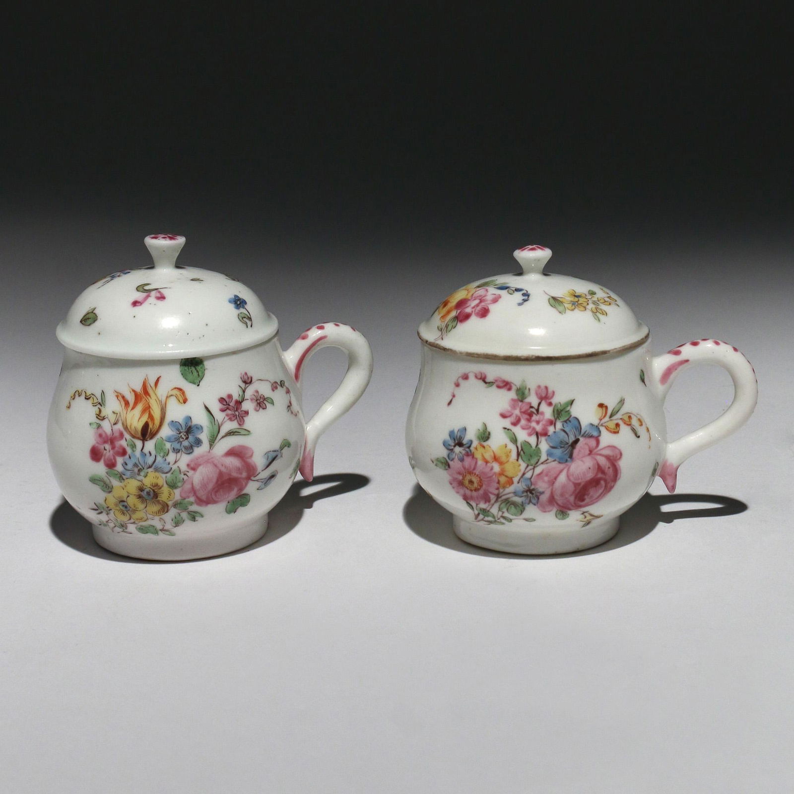 PAIR MENNECY PORCELAIN POT-DE-CREMES: 18th Century, both lidded with floral decoration on white, one with incised â€˜D.V.â€™ marks h. 3 in. Provenance: Estate of John F. Ball, Television and Film Production Executive, Greenwich,