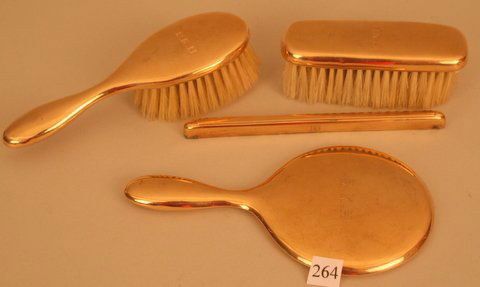 264) 3 PC. 14KYG CARTIER CHILD'S DRESSER SET: CLO: 264) 3 PC. 14KYG CARTIER CHILD'S DRESSER SET: CLOTHES BRUSH W/A DING, HAIRBRUSH, W/2 DINGS, HAND MIRROR & NON MATCHING TIFFANY & CO. 14KYG COMB SURROUND, ALL MONOGRAMMED, L. OF BRUSH 5 ½"