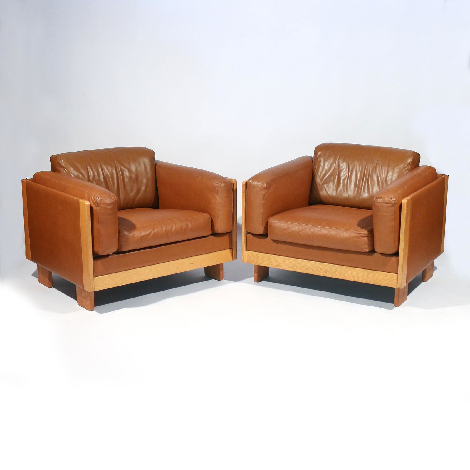 PAIR TOBIA SCARPA | CASSINA CLUB CHAIRS: 1960s/70s, ash and tan leather, one with Cassina label under seat h. 28 (over cushion) w. 35 d. 30 in.