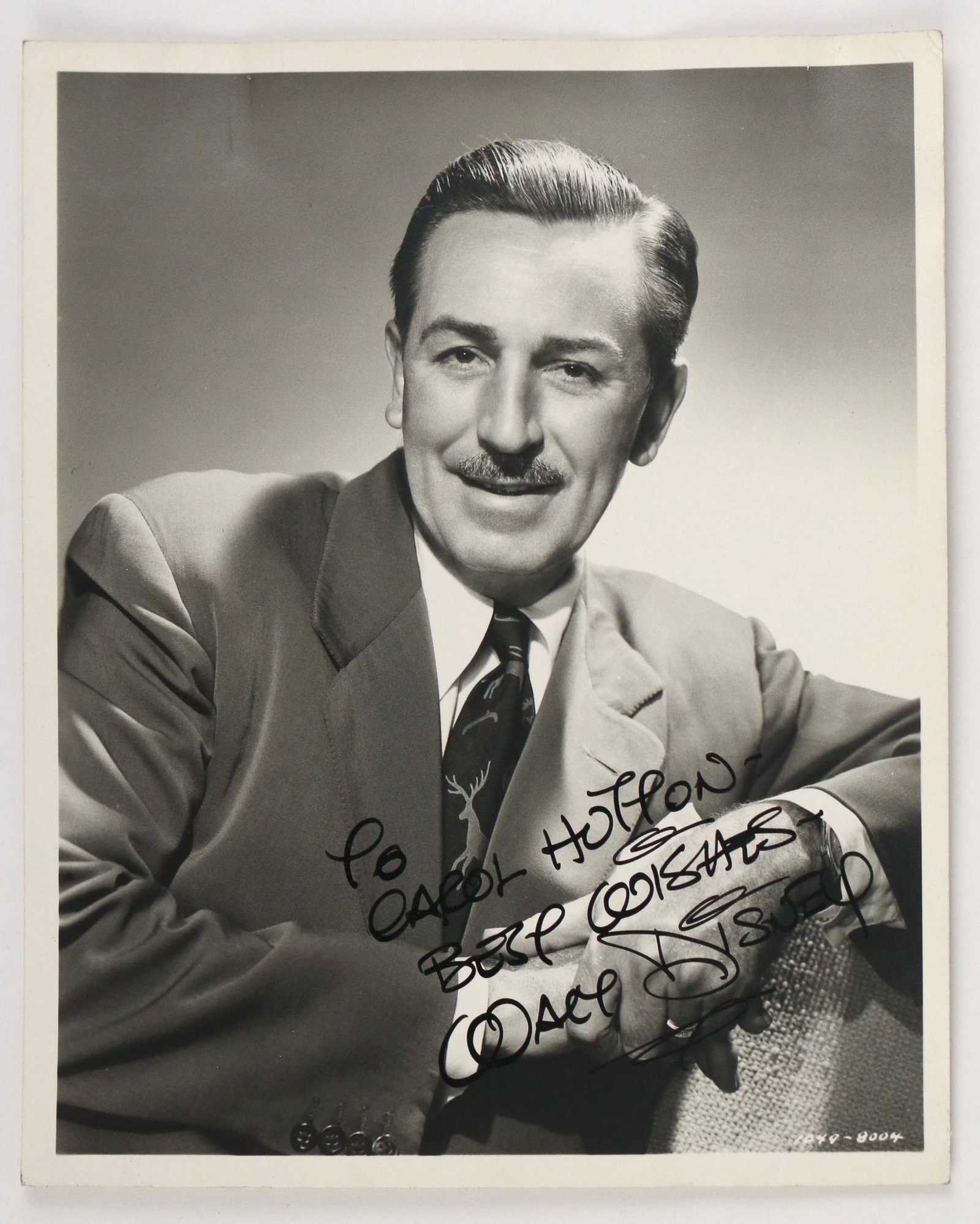 STUDIO-SIGNED WALT DISNEY PHOTOGRAPH: a photograph of Walt Disney with a studio / secretarial signature, reading 'To Carol Holton / Best Wishes / Walt Disney', very good condition