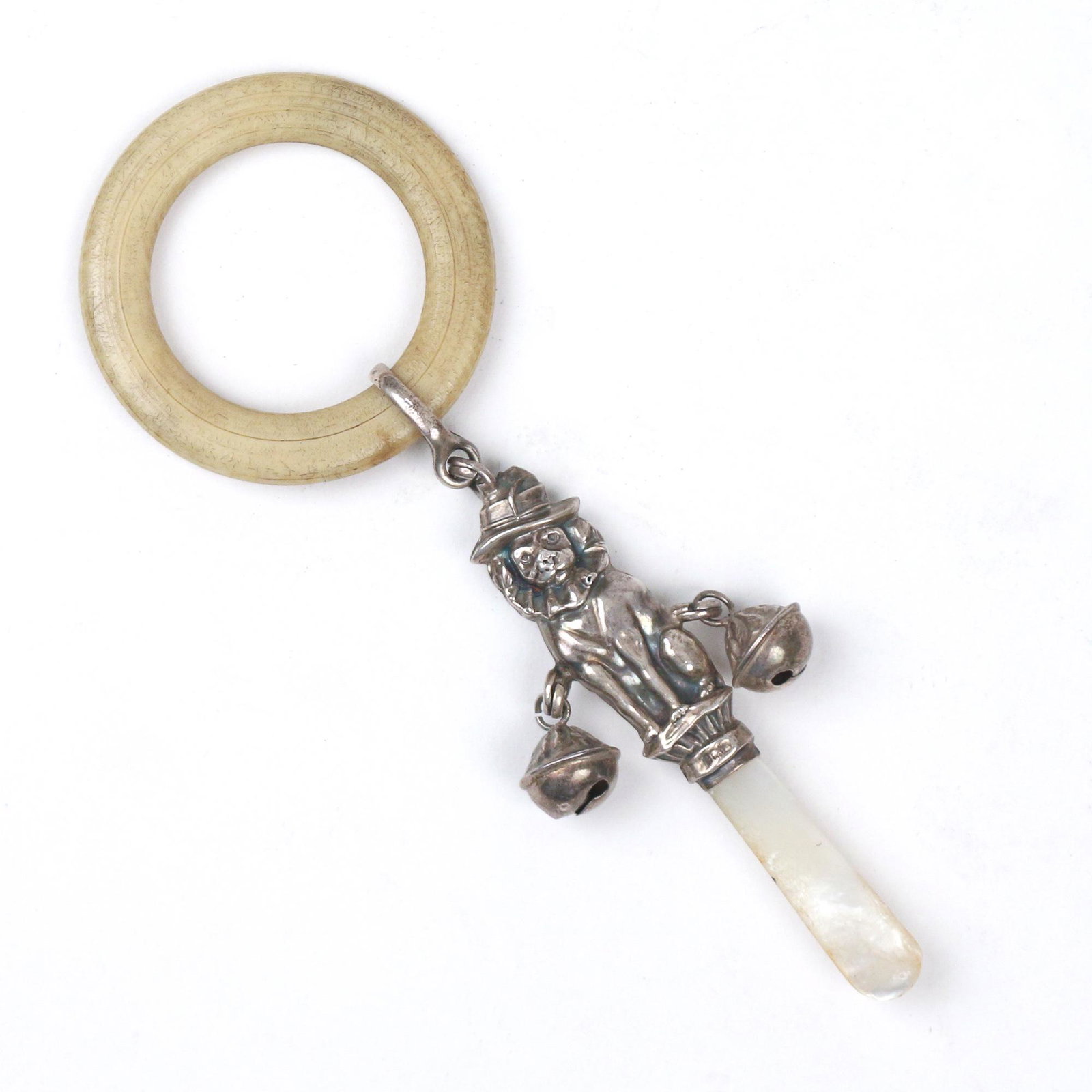 ENGLISH SILVER BABY RATTLE: late 19th Century, in the form of a dog dressed as a clown and having two bells and a teething ring, mother-of-pearl handle h. 5-1/2 in.