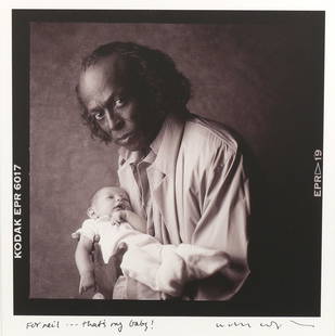 WILLIAM COUPON (b. 1952), MILES DAVIS: pigment print of Miles Davis holding the photographer's grandchild Hayley, c. 1986; signed and inscribed in ink by the photographer, a note to Neil Leifer; in a wood frame h. 11 w. 10-3/4 in.