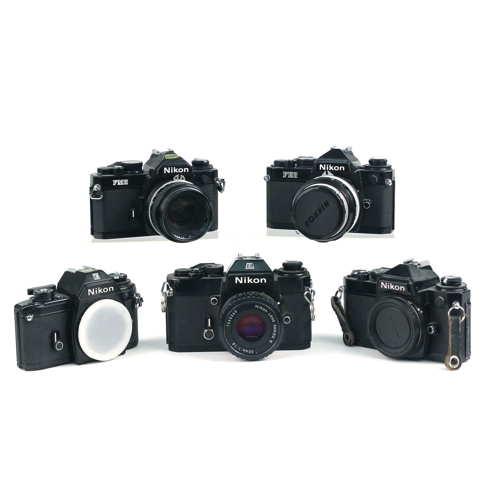 (5pc) BLACK NIKON FILM CAMERAS: including a Nikon EL2 with a 50mm Series E lens, a Nikon FE (no lens), a Nikon EN (no lens), a Nikon FE2 with a Nikkor-S 50mm lens, and a Nikon FM2 with a Nikkor 50mm lens h. 4 w. 5-1/2 d. 4-1/2 in. (
